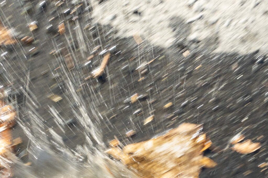 Photograph; a picture with motion blur, water splashing in a puddle 