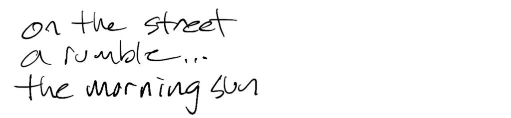 Haiku; on the street / a rumble… / the morning sun